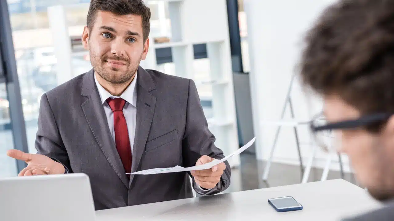 man talking to someone with paper