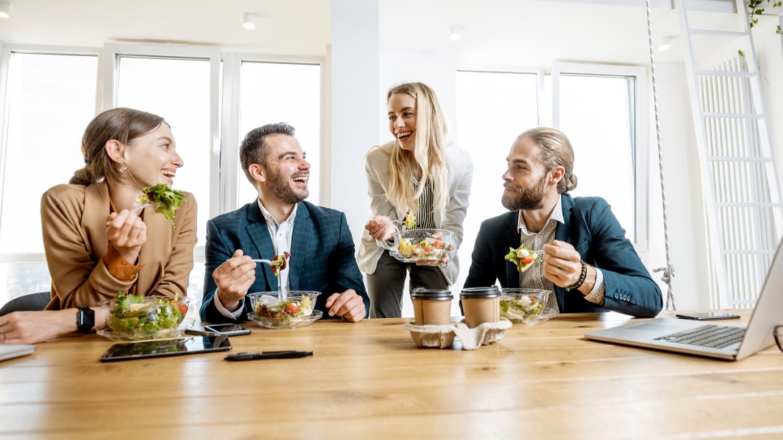 15 Office Rules That Quietly Grow Their Income Group of young people meeting for lunch