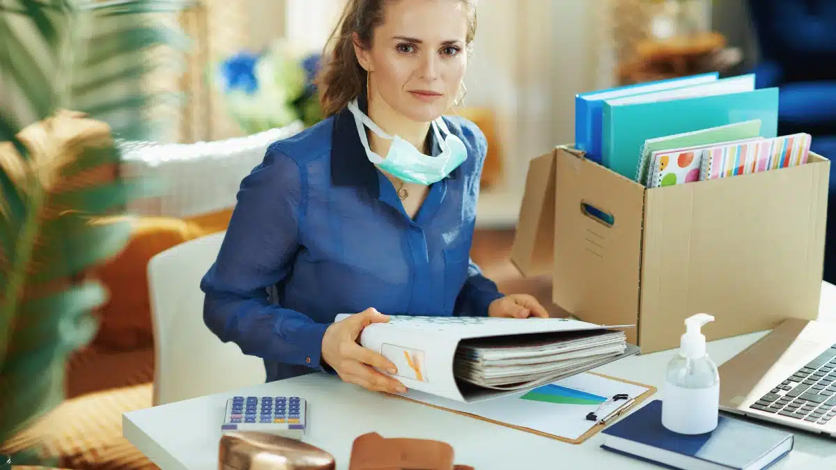 Portrait of stylish female in blue blouse with medical mask organising a t
