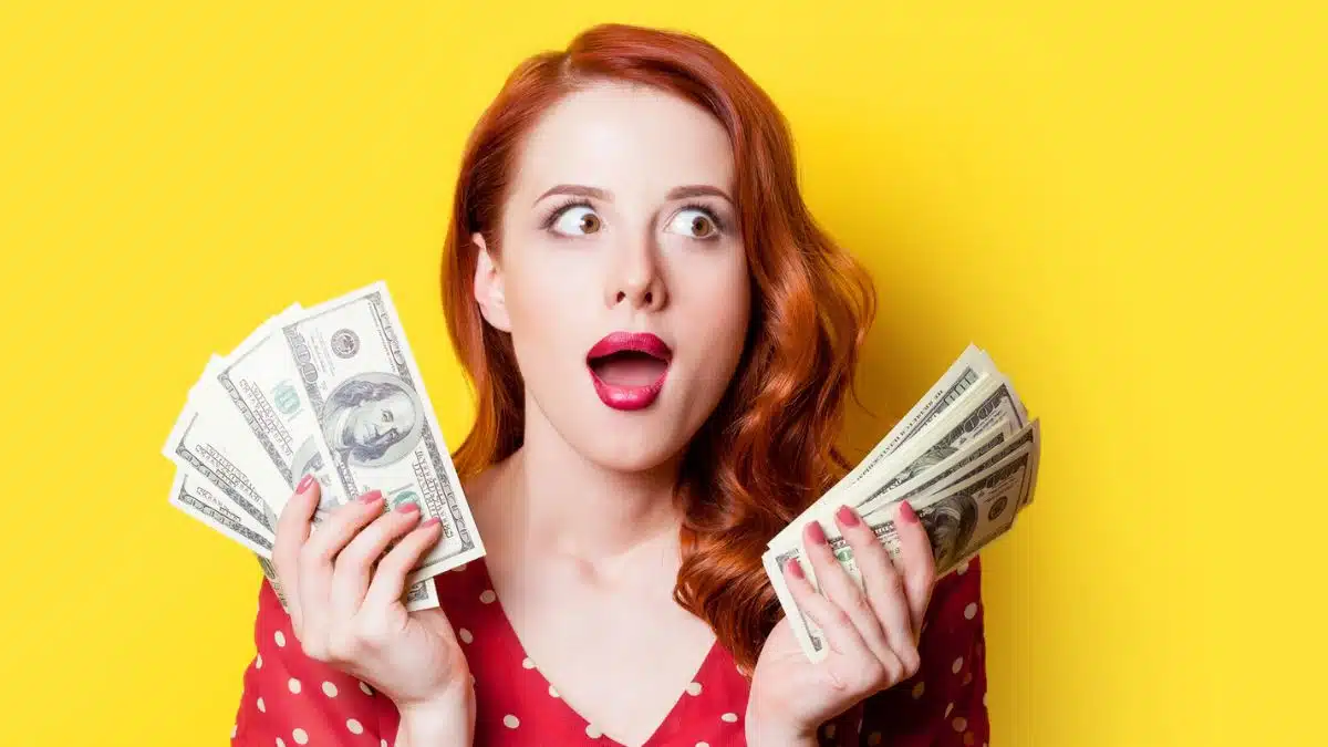 woman holding up cash