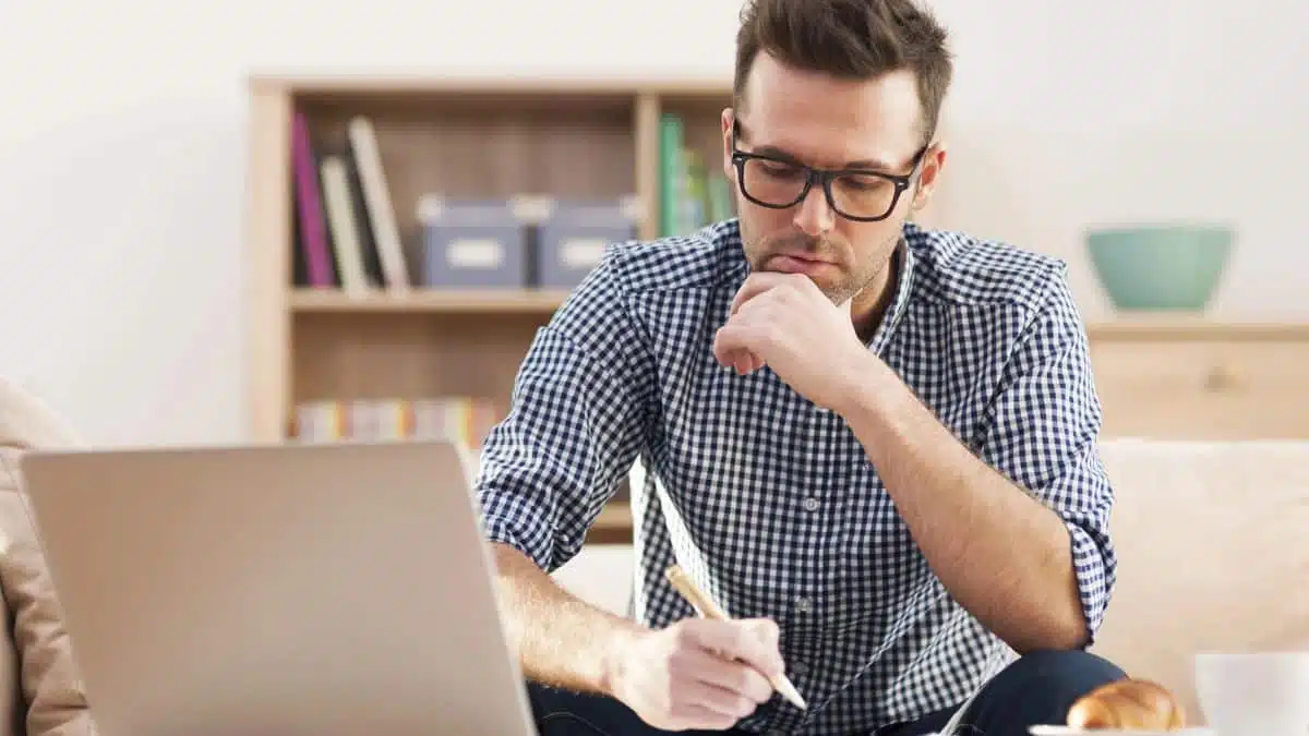 15 Office Rules That Quietly Grow Their Income man-working-on-a-computer-glasses