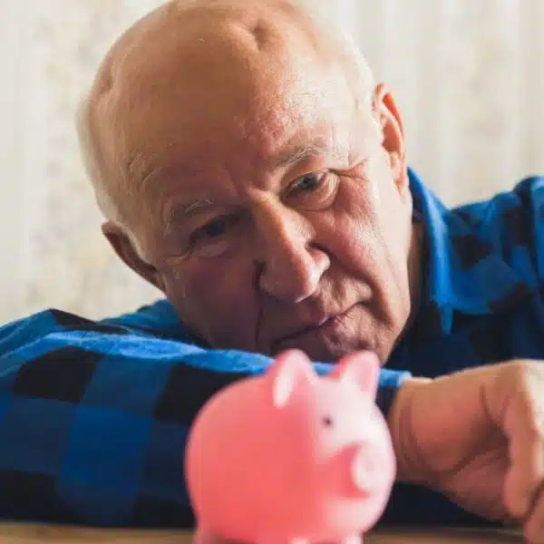 man laying down with piggy bank