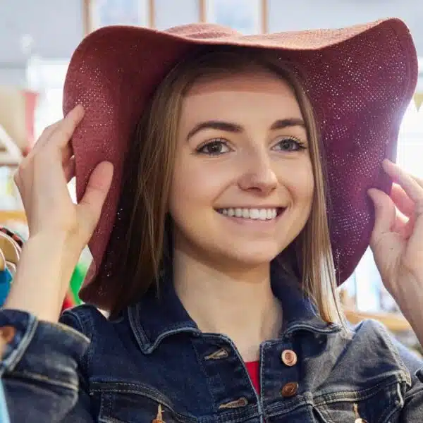 woman in store wearing a hat