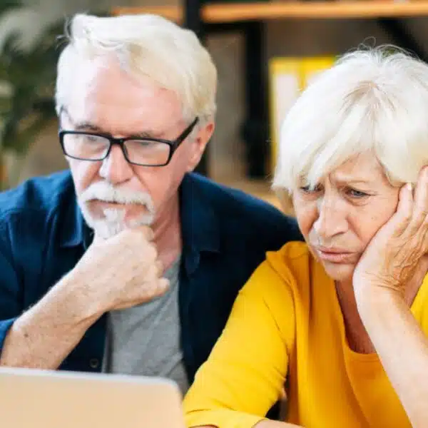 elder couple stressed looking at computer (1)
