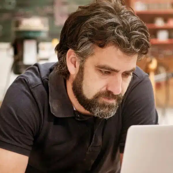 man beard sitting at desk working at home