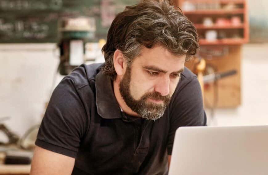 man beard sitting at desk working at home