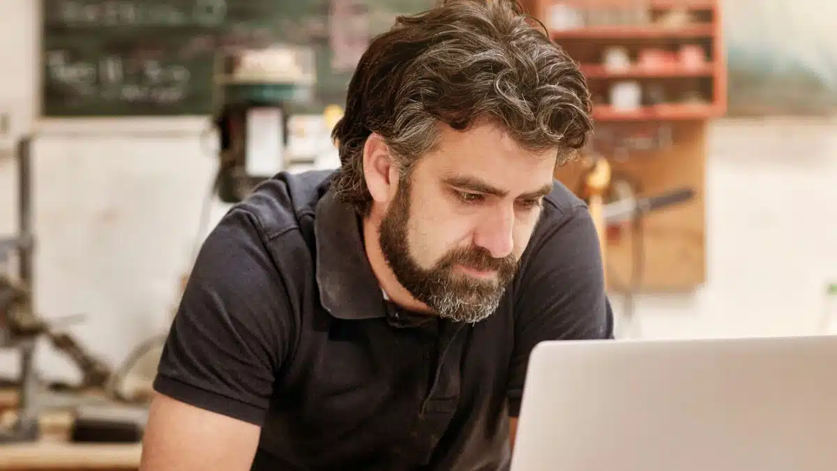 man beard sitting at desk working at home