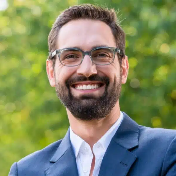 man in business suit crossed arms beard