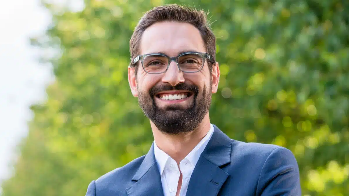 man in business suit crossed arms beard