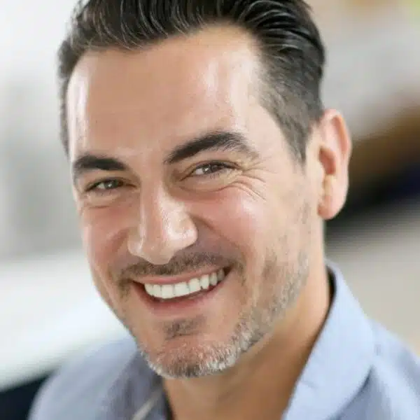 man smiling at his home
